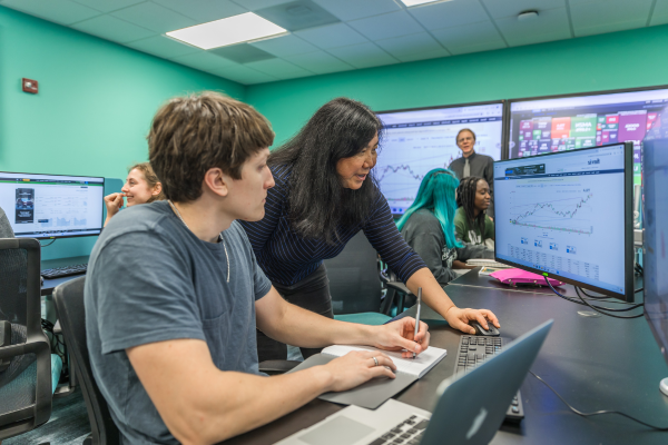 Student and teacher looking at computer screen